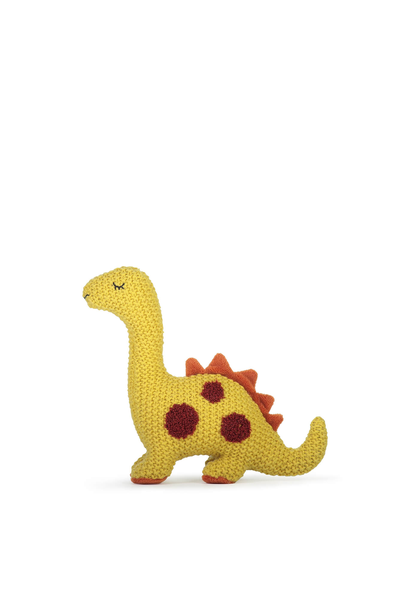 Yellow toy dinosaur photographed in studio Auckland NZ