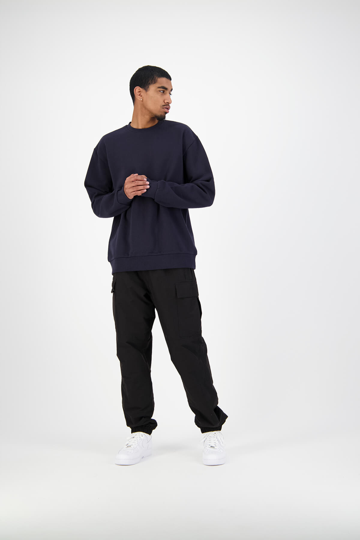 Huffer male model in studio wearing navy crewneck