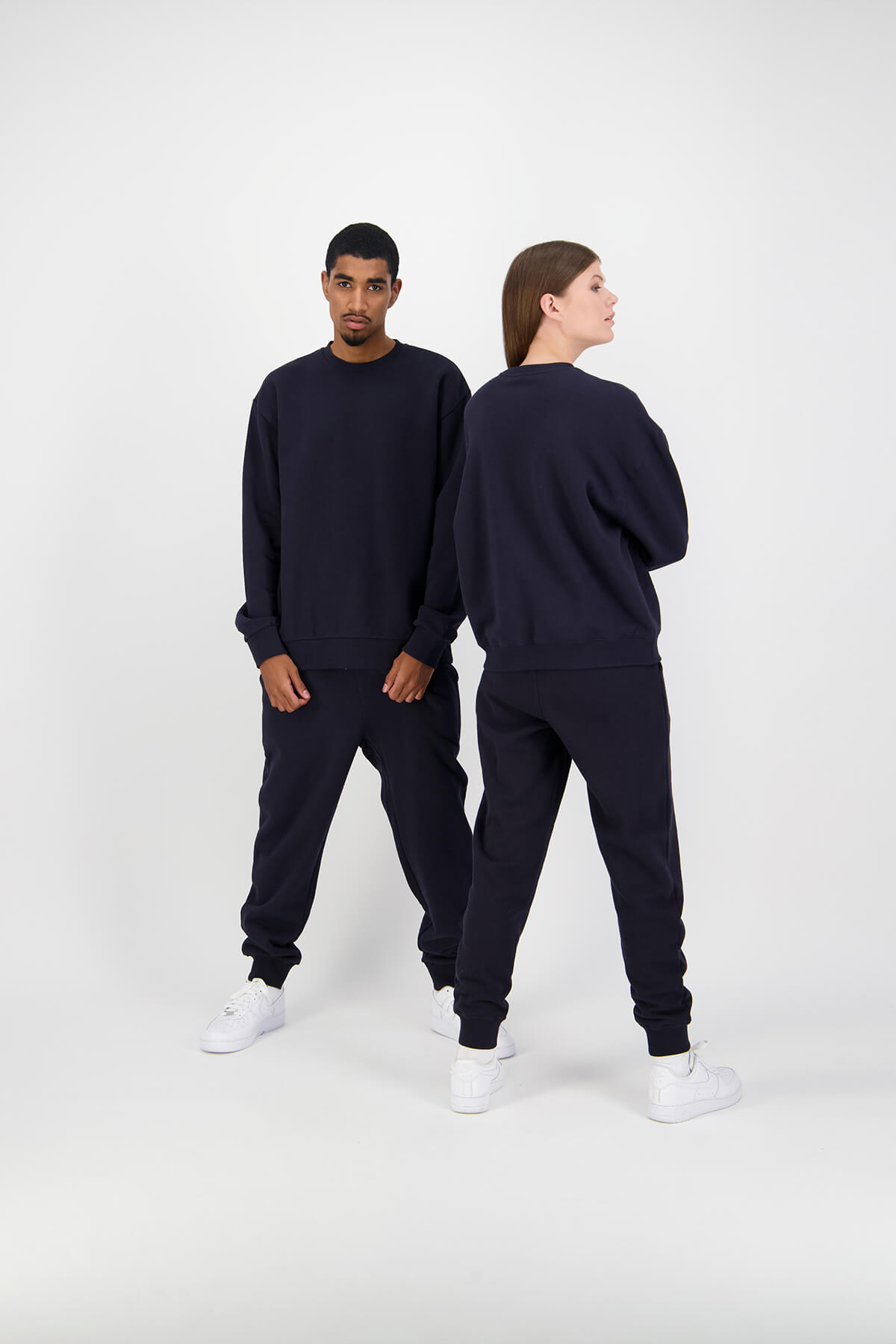 Female and Male HUFFER models wearing black tracksuits