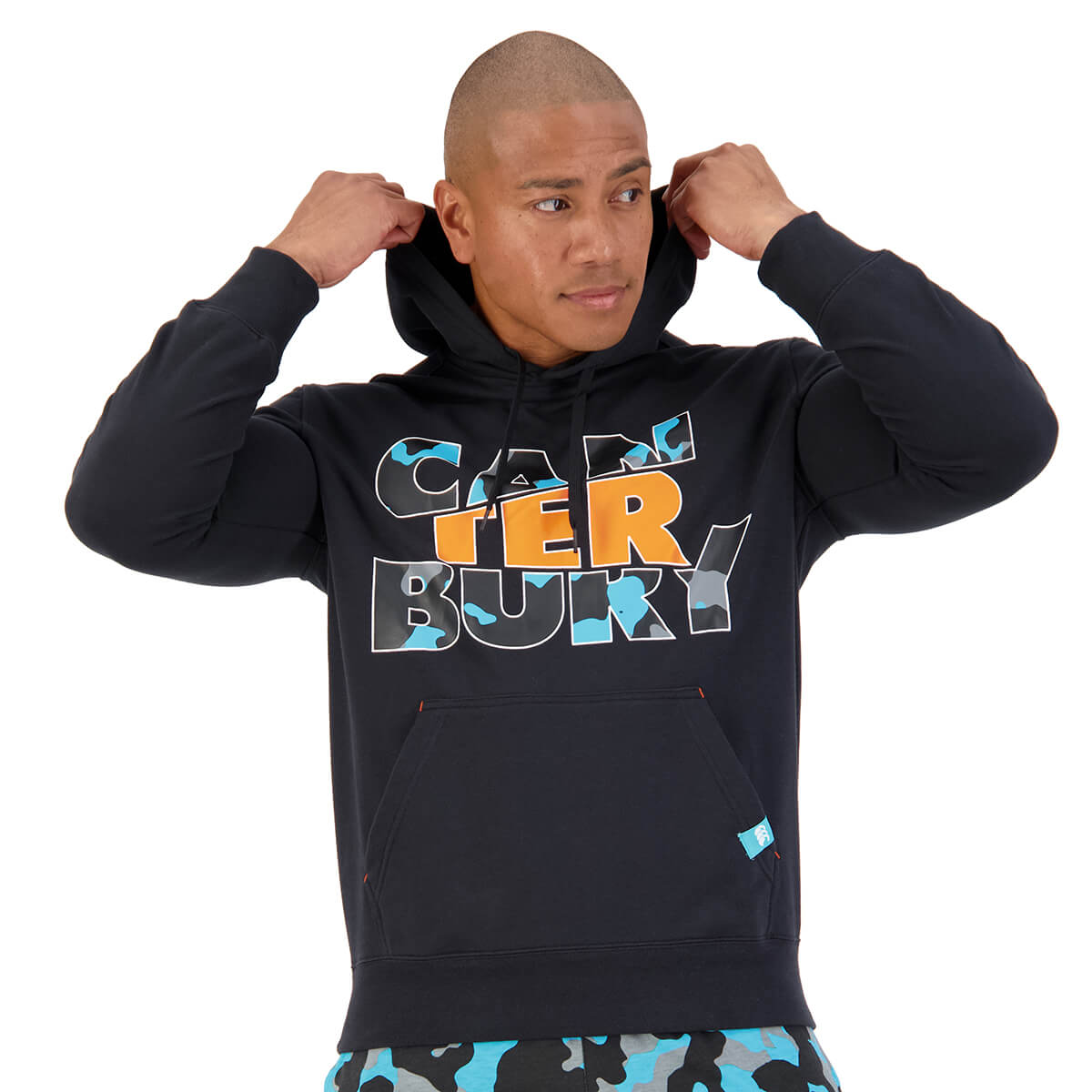 Canterbury NZ Model male wearing a logo hoodie in dark blue with orange text