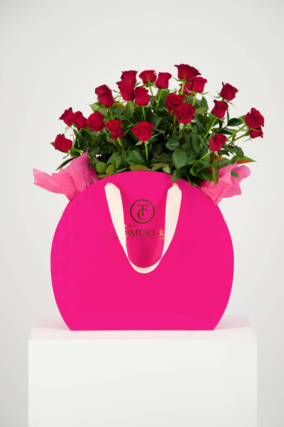 Red roses in pink box product photography Auckland Studio on white Plinth