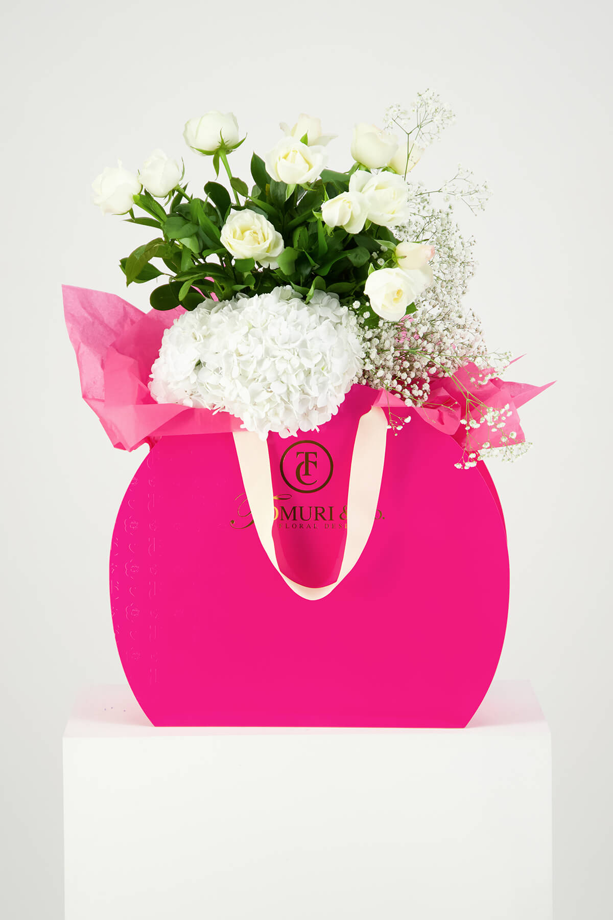 White flowers in pink box product photography Auckland Studio on white Plinth