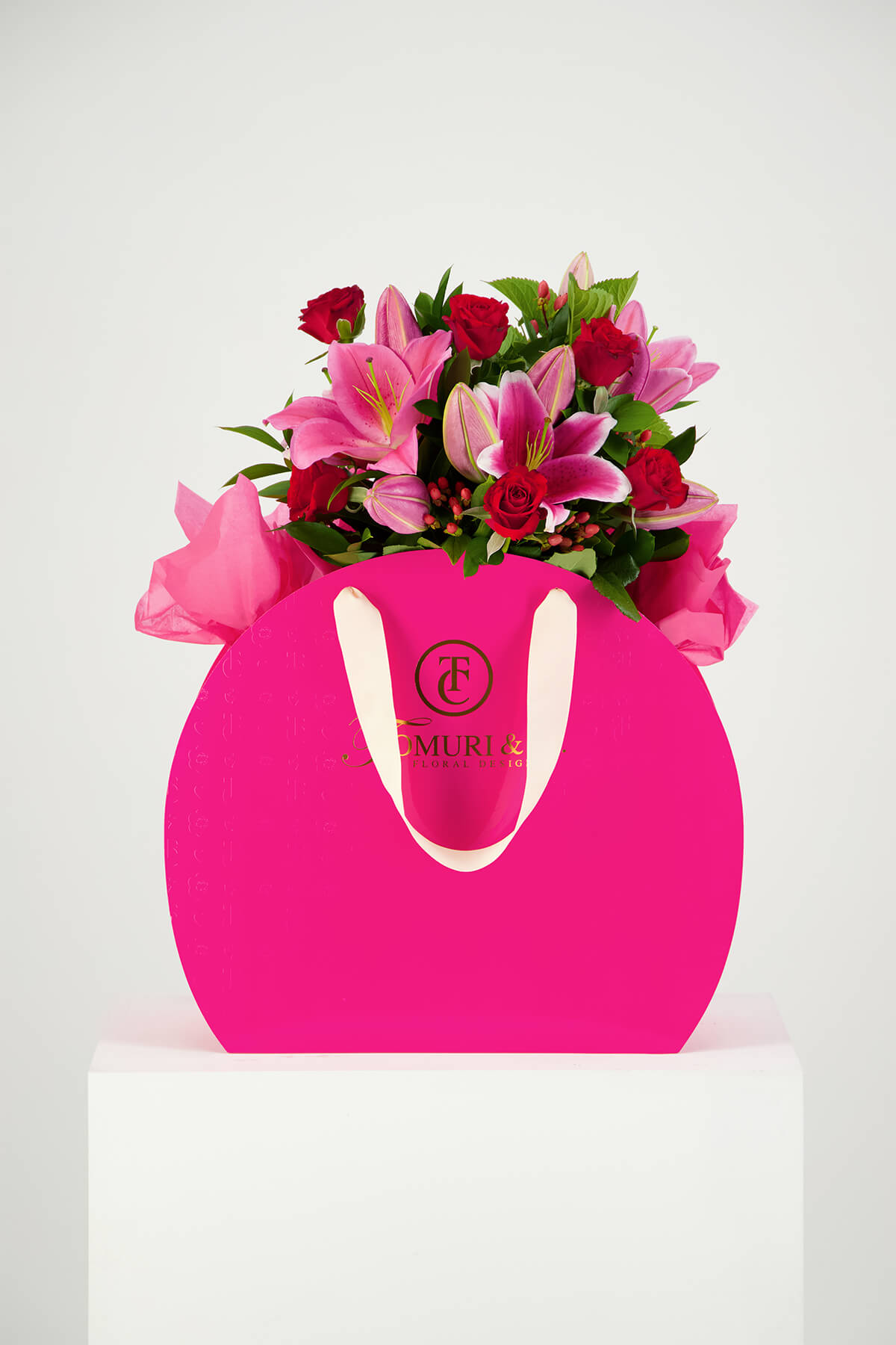 Bunch of lilies in pink box product photography Auckland Studio on white Plinth